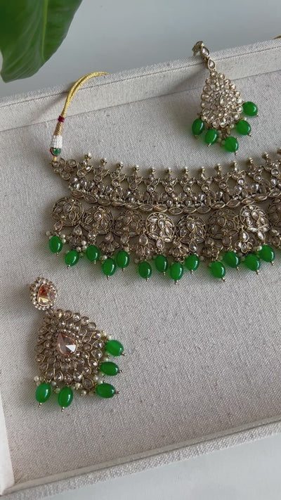Festive Essentials - Kiran Choker Set is a beautiful set that comes in several colors.  Pieces: Choker, Earrings and Tikka  If you want any specific color other than mention above, please contact us on whatsapp at +1 (313)-727-1045.